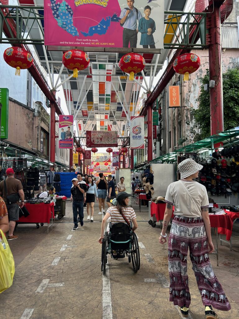 Wheelchair user exploring Petaling St, Kuala Lumpur
