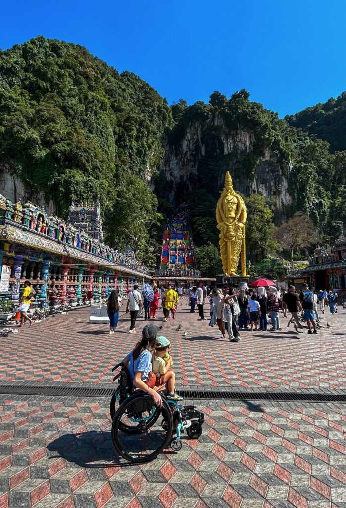Wheelchair user looking at Batu Caves